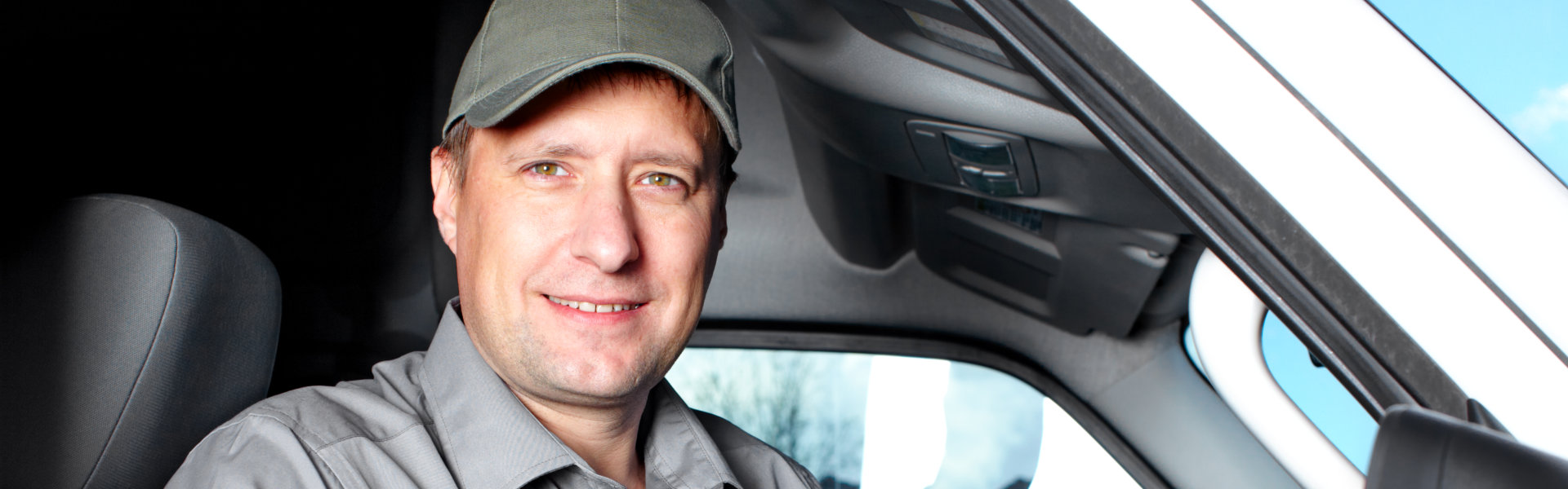 truck diver in truck smiling